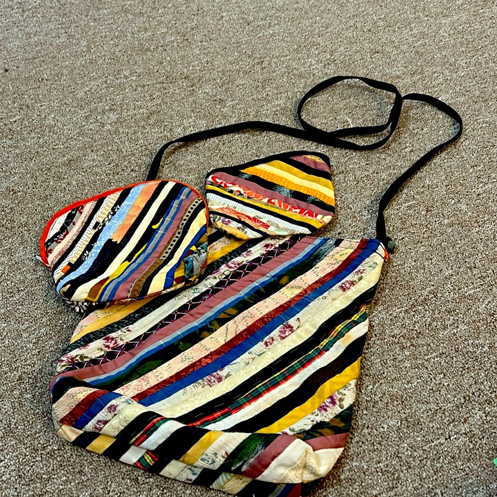 Arty shoulder bag with matching medium and small zipper pouches.